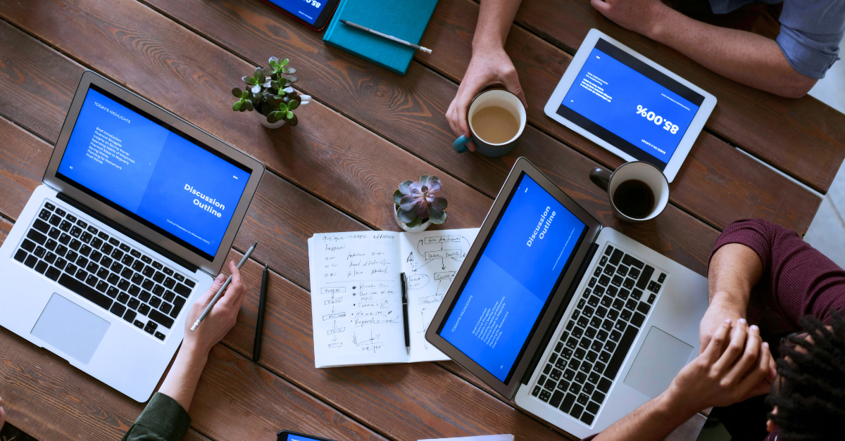 Team members working on different devices all protected with endpoint privilege management