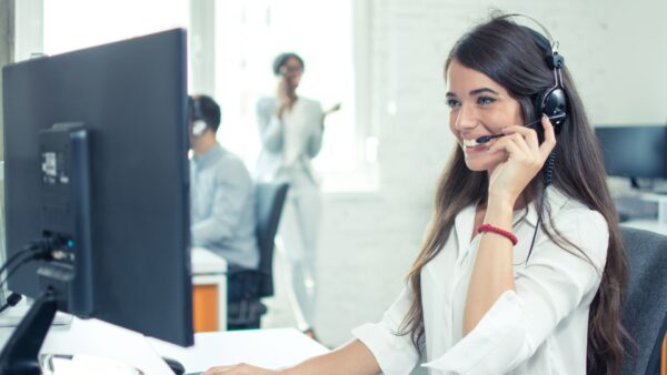 Woman working at a call center on her desktop computer
