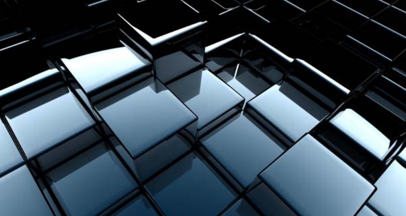 Abstract image of reflective, overlapping glass-like cubes arranged in a geometric pattern