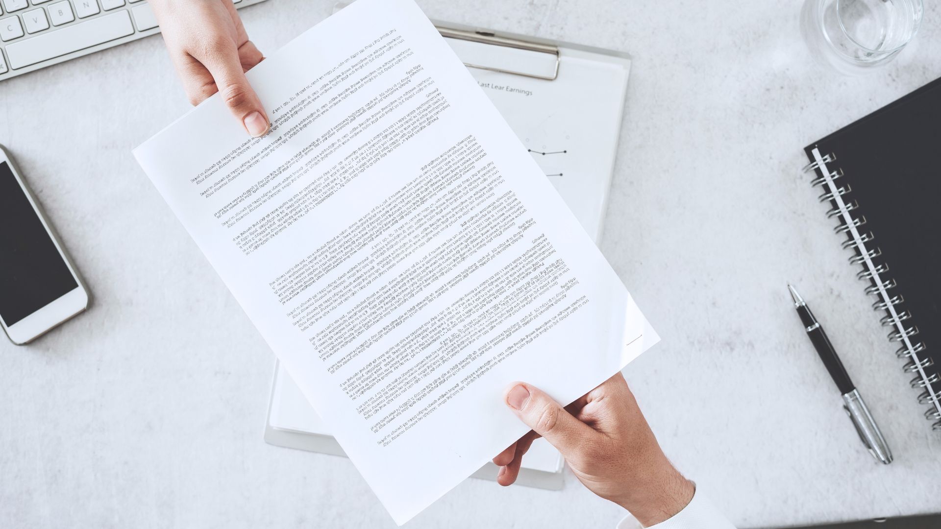 A document being handed to a person