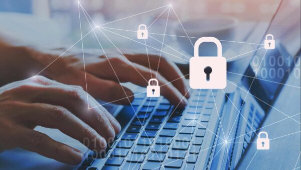 Person working on a laptop with an overlay of locks to represent security