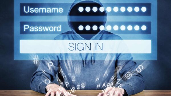 Hacker entering a username and password into a sign in page