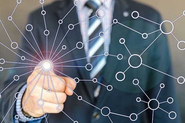 an abstract image of a man pointing at one of many  connected dots that overlay the image