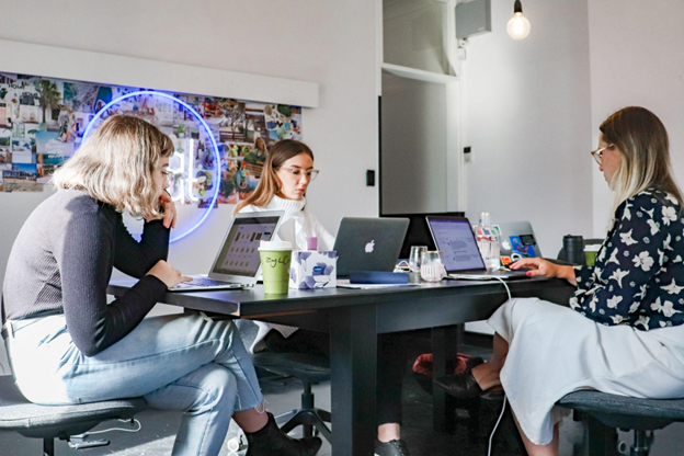 Three women working on their laptops. 